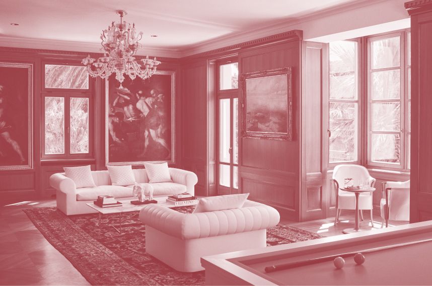 Classic living room with a white sofa, billiards table, ornate chandelier, and framed artwork, with sunlight streaming in through window shutters, red hue.
